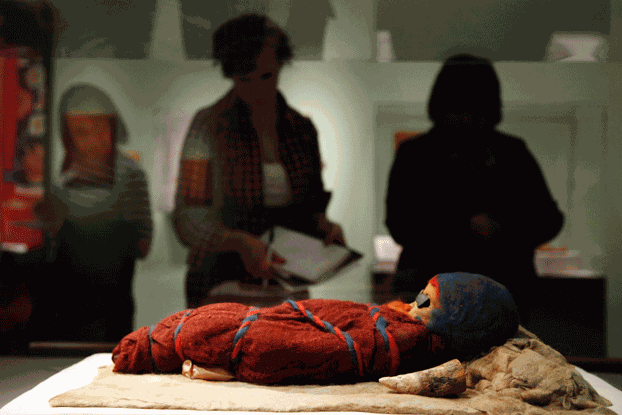 Members of the media view an infant mummy discovered in the Tarim Basin in northwestern China, at the 'Secrets of the Silk Road' exhibit at the University of Pennsylvania Museum of Archaeology and Anthropology in Philadelphia, Pennsylvania, Feb. 18, 2011. Credit: Associated Press