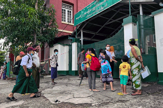 Students and their parents wait outside the entrance of the No. 3 Basic Education High School in Mingalar Taung Nyunt township, Yangon, Myanmar, June 2, 2022. Credit: RFA