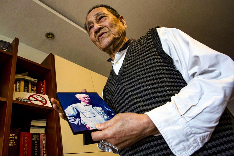 In this April 23, 2014 photo, Bao Tong, aide to the late reform-minded former Communist Party general secretary, Zhao Ziyang, holds up a photo of Zhao as he speaks from his home in Beijing, China. Credit: AP