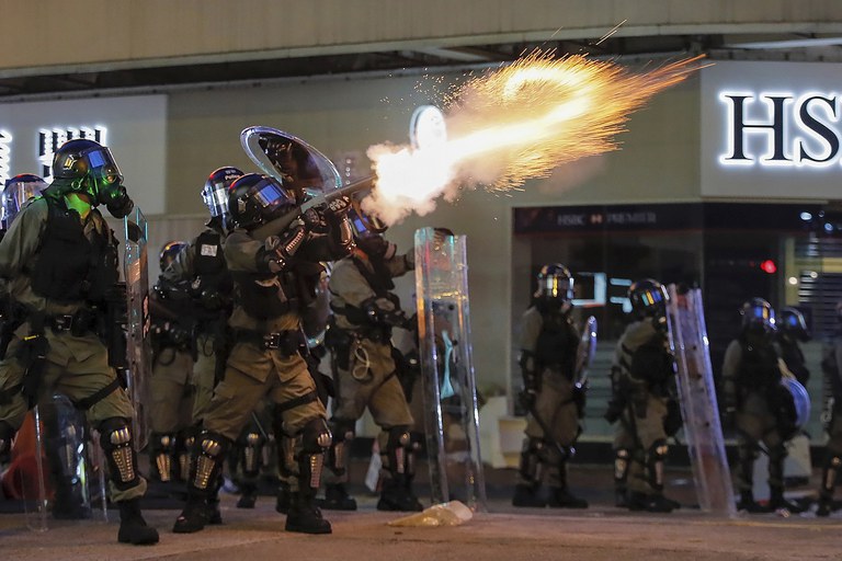 Riot police fire tear gas during the anti-extradition bill protest in Hong Kong, Aug. 11, 2019. Credit: AP Photo