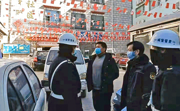 Officials wearing protective face masks stand on a street during the coronavirus pandemic in Lhasa, capital of western China's Tibet Autonomous Region, 2020. Credit: RFA