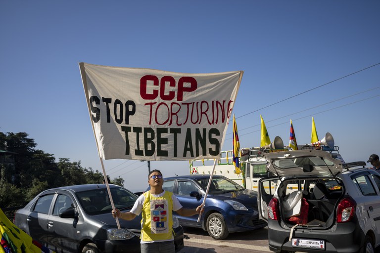 A man holds a banner as a small group of exile Tibetans mark the 20th National Congress of China's ruling Communist Party in Beijing with a protest in Dharamshala, India, Oct. 16, 2022. Credit: AP