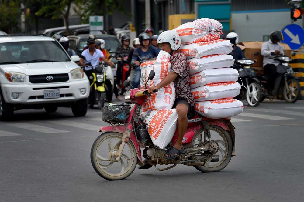 A man transports bags of rice in Phnom Penh, Cambodia, Oct. 17, 2019. Credit: AFP