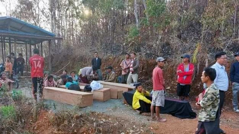 Families sit next to the coffins of victims of Myanmar military junta's airstrike in Webula town, Chin state, on April 11, 2023. Credit: Citizen Journalist