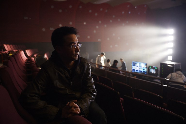 Tibetan filmmaker Pema Tseden sits in the Beijing Film Academy theater in Beijing before a screening of his film “Tharlo,” Nov. 12, 2015. Credit: AFP