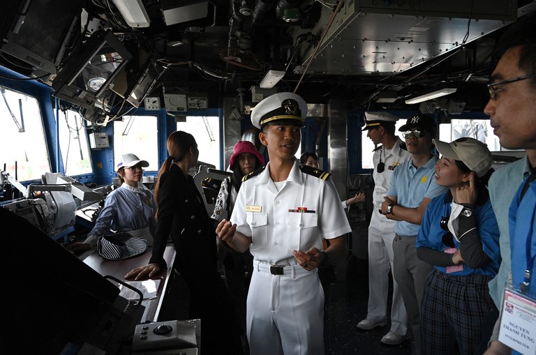 A U.S. Navy officer explains the control room to visitors on the guided missile cruiser Robert Smalls during a port visit in Danang, Vietnam, June 26, 2023. Credit: Nhac Nguyen/AFP