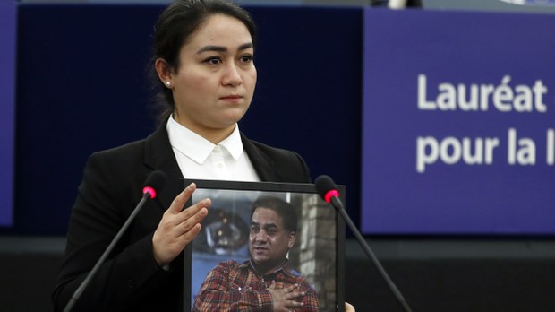 Jewher Ilham holds a photo of her father, Ilham Tohti, during the Sakharov Prize ceremony at the European Parliament, in Strasbourg, France, Dec. 18, 2019.  Credit: AP Photo