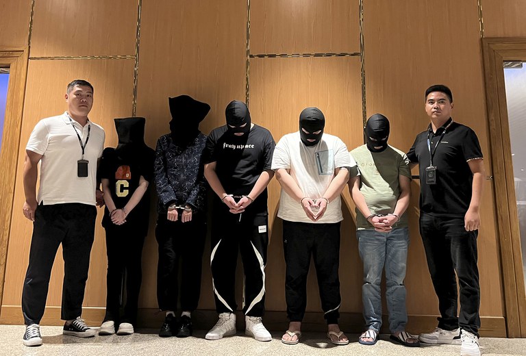 Five telecom and internet fraud suspects who were handed over to the Chinese police pose for a photo at Yangon International Airport in Yangon, Aug. 2023. (Chinese embassy in Myanmar/Xinhua via AP)