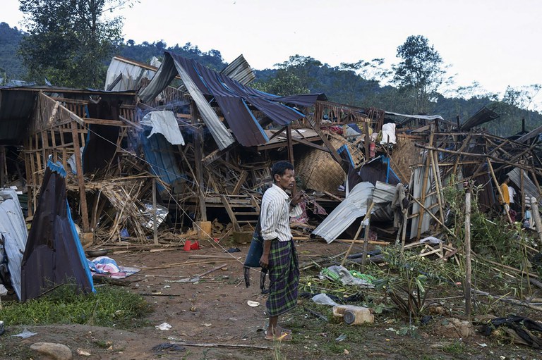 A man looks on at homes destroyed after air and artillery strikes in Mung Lai Hkyet displacement camp in northern Kachin state, Oct. 10, 2023. (AP Photo)