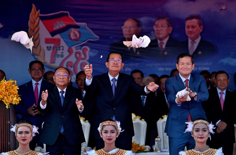 Leader of Cambodian People's Party Hun Sen and his son Prime Minister Hun Manet release pigeons during a ceremony to mark the 45th anniversary of the fall of the Khmer Rouge regime in Phnom Penh on Jan. 7, 2024. (Tang Chhin Sothy/AFP)