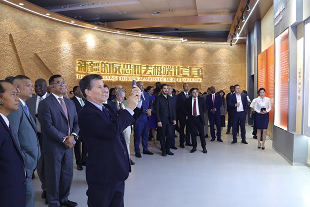 Foreign envoys visit an exhibition on Xinjiang's anti-terrorism and de-radicalization work in Urumqi, capital of northwestern China's Xinjiang region, Aug. 4, 2023. (Zhao Chenjie/Xinhua via Getty Images)