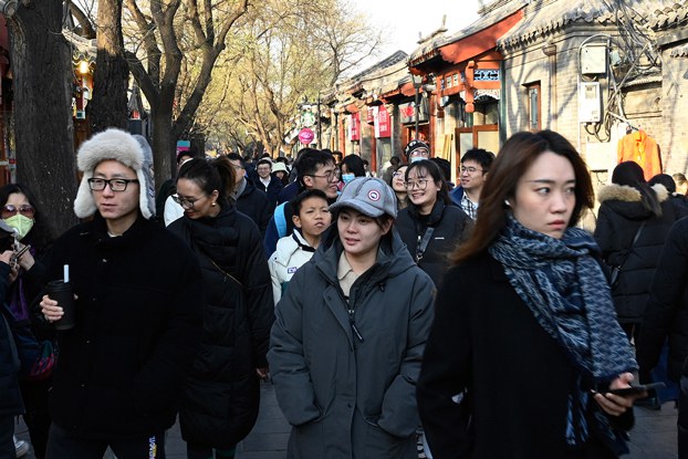 People walk along a street in the Dongcheng district of Beijing, Dec. 3, 2023. (Pedro Pardo/ AFP)