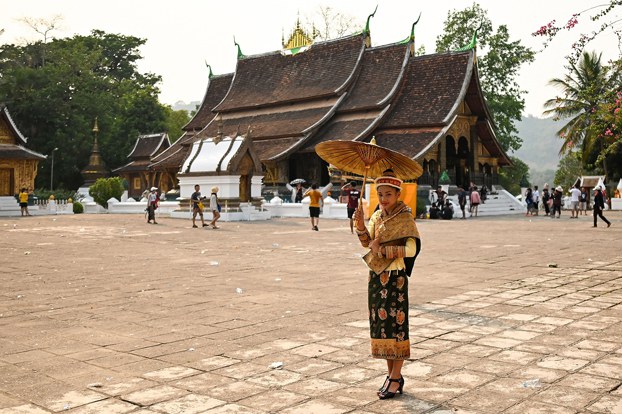 A tourist visits the Haw Pha Bang temple in the grounds of the Palace Museum in Luang Prabang, Laos, Sept. 8, 2014. (Mark Baker/AP)