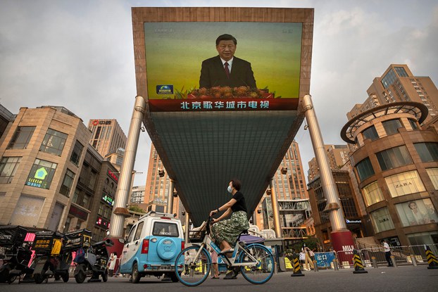 A large television screen at a Beijing shopping center displays Chinese state television coverage of President Xi Jinping's visit to Hong Kong, July 1, 2022. (Mark Schiefelbein/AP)