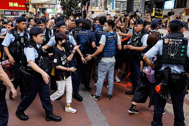 Police detain a person in downtown Hong Kong on the 34th anniversary of the 1989 Beijing's Tiananmen Square crackdown, near where the candlelight vigil is usually held, June 4, 2023. (Tyrone Siu/Reuters)
