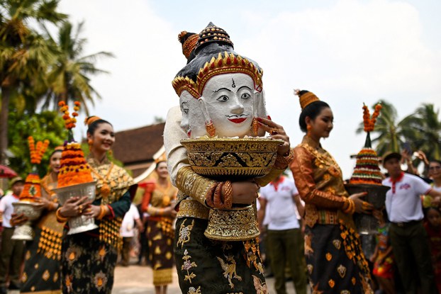 Miss Laos New Year carries a replica of King Kabinlaphom's head during the annual Laos New Year or 'Pi Mai' celebrations at the Wat Xiengthong Buddhist temple in Luang Prabang, Laos, April 15, 2019. (Manan Vatsyayana/AFP)