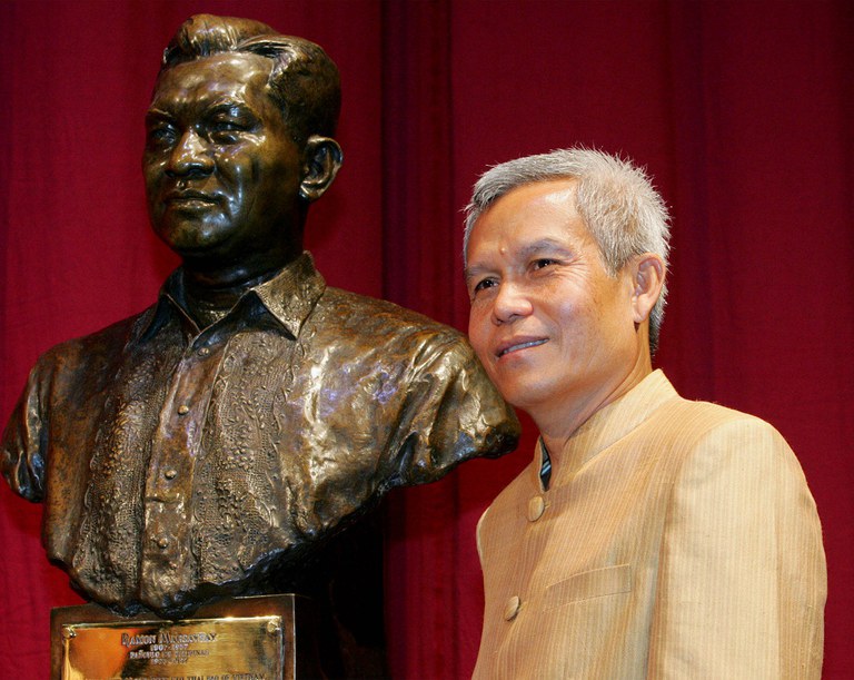 Sombath Somphone of Laos, the winner of the Ramon Magsaysay Award for Community Leadership in 2005, poses with the bust of the late Philippine president before receiving the award in Manila, Aug. 31, 2005. He was abducted in Vientiane in 2012 and has not been seen since. (Bullit Marquez/AP)